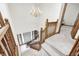Well-lit staircase with chandelier, wooden railings, neutral carpeting, and entryway view at 7688 Gunsmith Ct, Plainfield, IN 46168