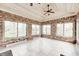 The sunroom has brick walls, a ceiling fan, and many windows at 7688 Gunsmith Ct, Plainfield, IN 46168