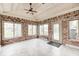 Cozy sunroom featuring brick walls, a ceiling fan, and large windows at 7688 Gunsmith Ct, Plainfield, IN 46168