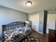 Cozy bedroom with neutral walls and wooden floors, and a metal bed frame at 8019 Gathering Ln, Indianapolis, IN 46259