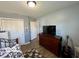 Bedroom with wooden floors, neutral gray walls, and closet doors at 8019 Gathering Ln, Indianapolis, IN 46259