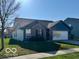 Lovely single-story home featuring blue siding and a spacious two car garage at 8019 Gathering Ln, Indianapolis, IN 46259