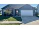 Charming single-story home with blue siding, brick accents, and a well-manicured front lawn at 8019 Gathering Ln, Indianapolis, IN 46259
