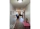 Bright hallway with wood floors that lead into the cozy living area at 8019 Gathering Ln, Indianapolis, IN 46259