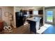 Modern kitchen featuring dark cabinetry, stainless steel appliances, and center island at 8019 Gathering Ln, Indianapolis, IN 46259