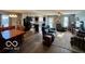Spacious living room adjacent to a modern kitchen with ample seating at 8019 Gathering Ln, Indianapolis, IN 46259