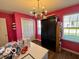 Bright office with a large window, craft supplies, decorative chandelier, and dark storage unit at 8019 Gathering Ln, Indianapolis, IN 46259
