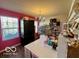 Bright office with a large window, craft supplies, decorative chandelier, and dark storage unit at 8019 Gathering Ln, Indianapolis, IN 46259