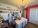 Well-lit office featuring a desk, storage shelves and a bright chandelier at 8019 Gathering Ln, Indianapolis, IN 46259