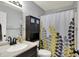 Cozy bathroom with modern fixtures, a vanity, and a patterned shower curtain at 902 Helm Dr, Avon, IN 46123