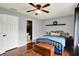 Cozy bedroom features hardwood floors, ceiling fan, and neutral tones with ensuite bathroom at 902 Helm Dr, Avon, IN 46123