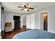 Comfortable bedroom featuring hardwood floors, a ceiling fan, and easy access to the bathroom at 902 Helm Dr, Avon, IN 46123