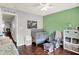 Bright bedroom with a crib, comfortable glider, and organized shelving for a cozy atmosphere at 902 Helm Dr, Avon, IN 46123