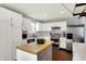 Modern kitchen with stainless steel appliances, white cabinets, butcher block island and pot rack at 902 Helm Dr, Avon, IN 46123