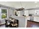 Cozy kitchen and dining area with white cabinets, butcher block countertops and modern lighting at 902 Helm Dr, Avon, IN 46123