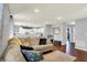 Comfortable living room with hardwood floors, neutral walls, and an open view to the kitchen at 902 Helm Dr, Avon, IN 46123