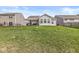 Back exterior view showcasing the lawn and overall home design at 9157 Tansel Crk Dr, Indianapolis, IN 46234