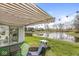 Backyard patio with awning, seating area, and scenic pond view at 9157 Tansel Crk Dr, Indianapolis, IN 46234