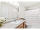 Bright bathroom with updated vanity, marble countertop, large mirror and shower with decorative curtain at 9157 Tansel Crk Dr, Indianapolis, IN 46234