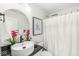 Stylish bathroom features granite countertop, decorative mirror, red flowers, and updated faucet at 9157 Tansel Crk Dr, Indianapolis, IN 46234