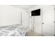 Neutral bedroom with on-suite bathroom, storage closet, wall-mounted television and comfortable bed at 9157 Tansel Crk Dr, Indianapolis, IN 46234