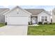 Charming single-story home with a two-car garage and well-maintained lawn at 9157 Tansel Crk Dr, Indianapolis, IN 46234