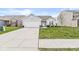 Inviting single-story home with a manicured lawn and a two-car garage at 9157 Tansel Crk Dr, Indianapolis, IN 46234