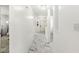 Hallway featuring marble floors, leading to a bright, welcoming front door at 9157 Tansel Crk Dr, Indianapolis, IN 46234