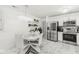 Bright kitchen featuring stainless steel appliances, a stylish light fixture, and a dining area at 9157 Tansel Crk Dr, Indianapolis, IN 46234
