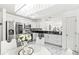 Well-lit kitchen featuring stainless steel appliances and a modern island with seating at 9157 Tansel Crk Dr, Indianapolis, IN 46234