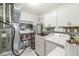 Functional laundry room with washer, dryer, shelves, and storage cabinets at 9157 Tansel Crk Dr, Indianapolis, IN 46234