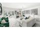 Bright living room featuring stylish white marble floors, modern decor, and fireplace with an open floor plan at 9157 Tansel Crk Dr, Indianapolis, IN 46234