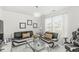 Modern living room with stylish black and white sofas, complemented by contemporary decor and natural light at 9157 Tansel Crk Dr, Indianapolis, IN 46234