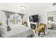 Comfortable main bedroom featuring sitting area with fireplace and a large picture window overlooking a lake at 9157 Tansel Crk Dr, Indianapolis, IN 46234