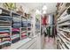 Organized walk-in closet with shelving, hanging racks, drawers, and storage for shoes and bags at 9157 Tansel Crk Dr, Indianapolis, IN 46234