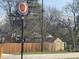 Fenced backyard with a storage shed and mature trees offering privacy and shade at 9169 Hibben Ave, Indianapolis, IN 46229
