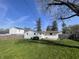Large backyard featuring a home exterior and fenced perimeter at 9169 Hibben Ave, Indianapolis, IN 46229