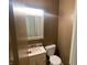 Powder room featuring a vanity with sink, lighting, mirror, and toilet at 9169 Hibben Ave, Indianapolis, IN 46229