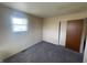 Bedroom featuring plush carpet, a window, and a closet for storage at 9169 Hibben Ave, Indianapolis, IN 46229