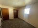 Bedroom featuring plush carpet, a window, and two closets for storage at 9169 Hibben Ave, Indianapolis, IN 46229