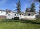 Home exterior with vinyl siding, a patio area, and a well-kept lawn at 9169 Hibben Ave, Indianapolis, IN 46229