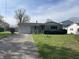 Charming single-story home with stone facade, attached garage, and well-maintained lawn at 9169 Hibben Ave, Indianapolis, IN 46229