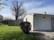 Attached garage with concrete drive surrounded by grass and privacy fence at 9169 Hibben Ave, Indianapolis, IN 46229