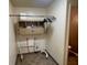 Functional laundry room with ample storage and a convenient hanging rack for clothes at 9169 Hibben Ave, Indianapolis, IN 46229