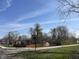 Charming neighborhood street scene with mature trees and well-maintained homes on a sunny day at 9169 Hibben Ave, Indianapolis, IN 46229