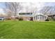 Lovely backyard showing a spacious lawn, deck, and the rear of a two-story home at 9270 N Temple Ave, Indianapolis, IN 46240