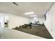 A large open basement features a home gym with rubber flooring and plenty of space for activities at 9270 N Temple Ave, Indianapolis, IN 46240