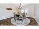 Cozy dining room with a round table, six chairs, and decorative rug on wood floor at 9270 N Temple Ave, Indianapolis, IN 46240