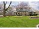 Charming two-story home with landscaped front yard, brick accents, and mature trees at 9270 N Temple Ave, Indianapolis, IN 46240