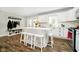 Well-lit kitchen with a large island, white cabinets, stainless steel appliances, and seating for four at 9270 N Temple Ave, Indianapolis, IN 46240